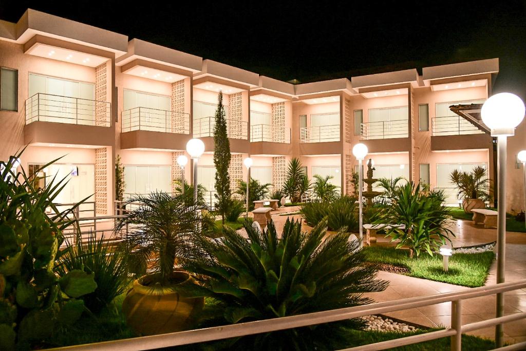 a building with a lot of plants in front of it at TRIUNFO PAPO HOTEL in Triunfo