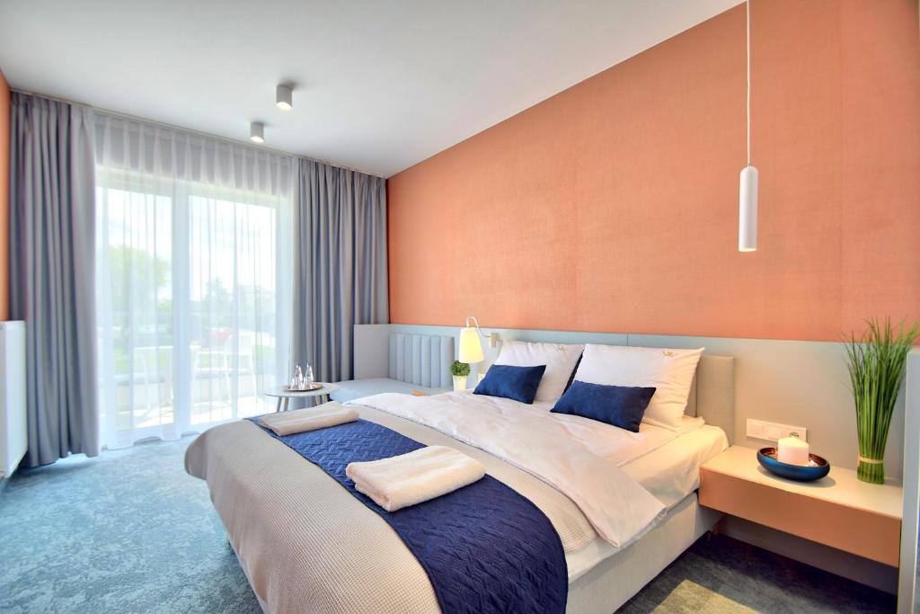 Postel nebo postele na pokoji v ubytování Savana Resort Mielno