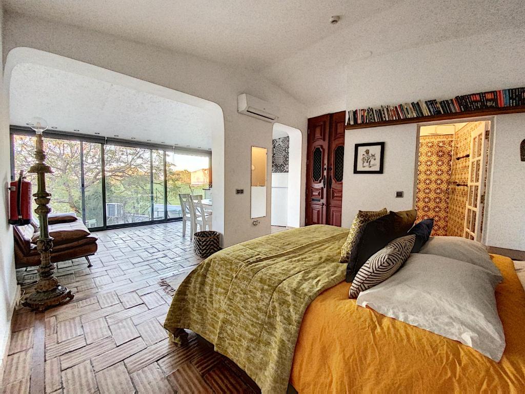 a bedroom with a bed and a large window at Monte Do Malhao - Art, Eco & Spa in Castro Marim