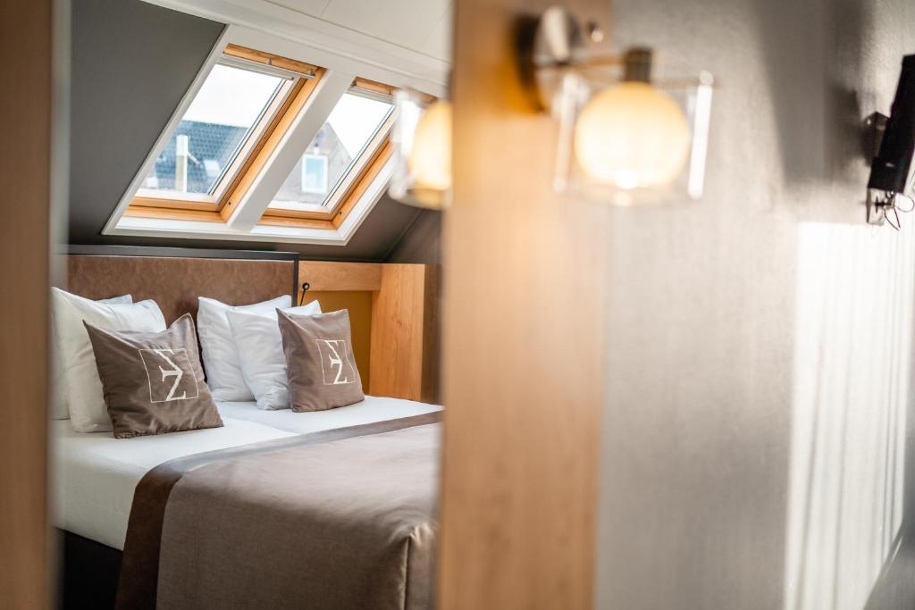 Postel nebo postele na pokoji v ubytování Hotel Zeezicht