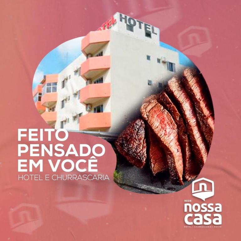 a sign with some meat on a plate with a building at Hotel Nossa Casa in Ijuí