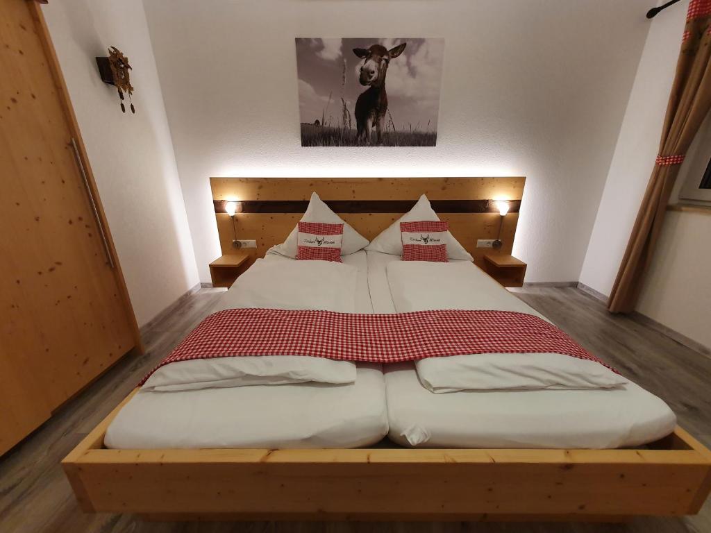 una camera da letto con un letto grande con struttura in legno di Gasthaus zum Hirschen a Furtwangen