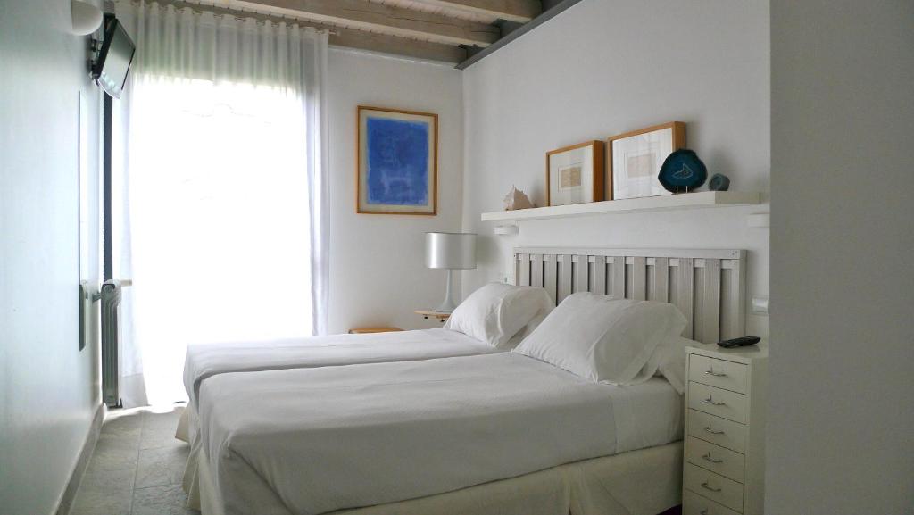 Postel nebo postele na pokoji v ubytování Las Villas de Cué