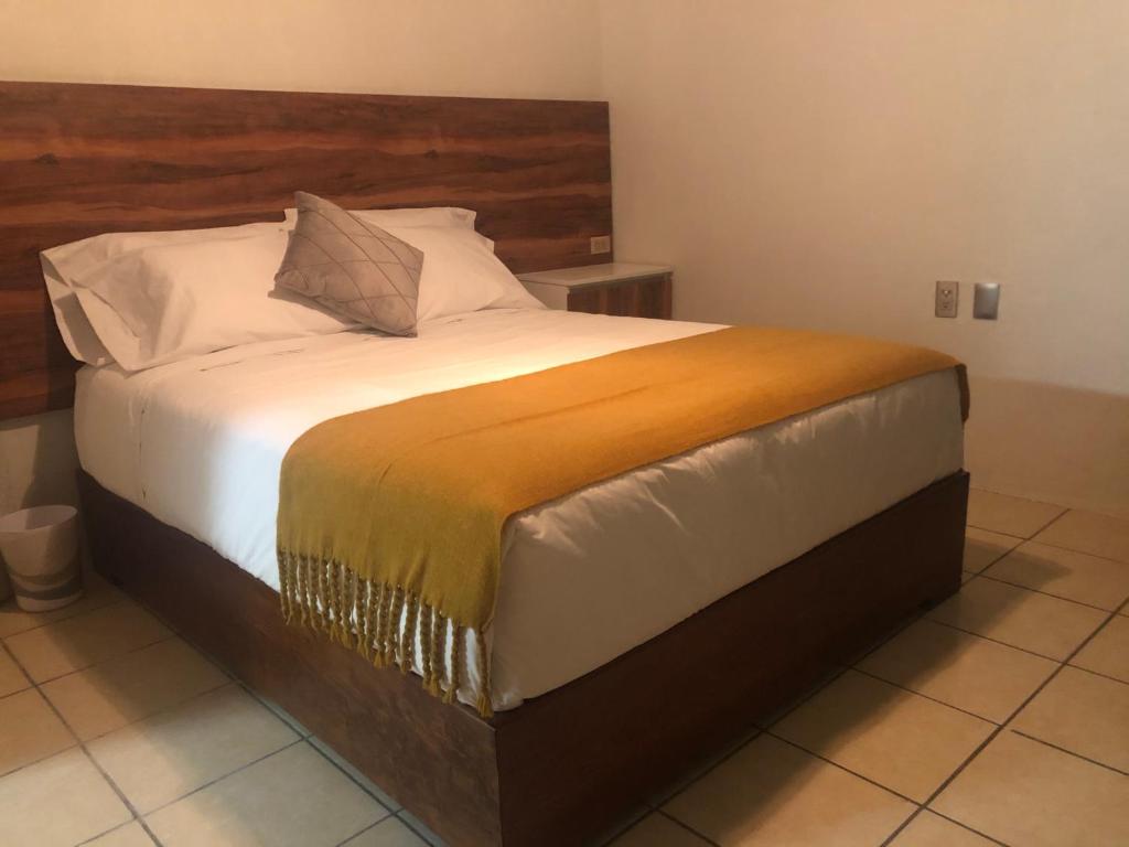 Postel nebo postele na pokoji v ubytování Hotel Orquídea