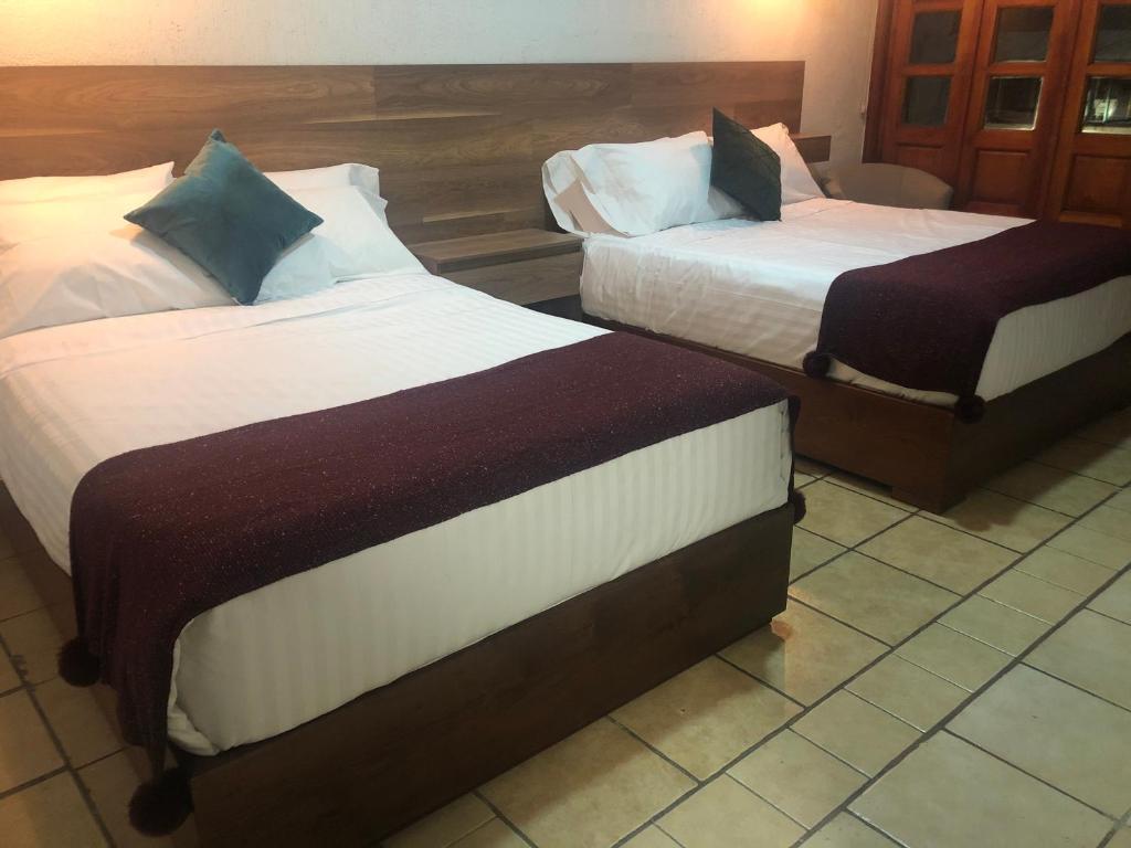Postel nebo postele na pokoji v ubytování Hotel Orquídea
