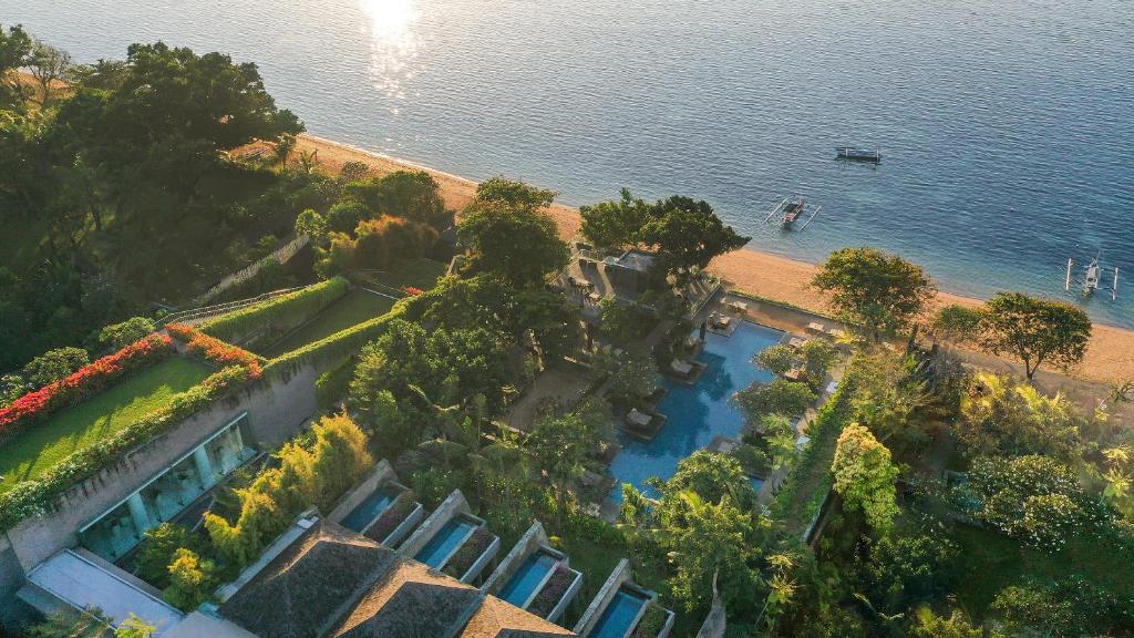 an aerial view of a house next to the water at Maya Sanur Resort & Spa in Sanur