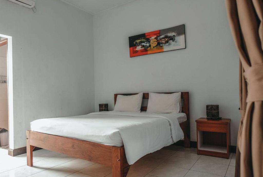 Postel nebo postele na pokoji v ubytování Sekar Arum Riverside Resort in Canggu
