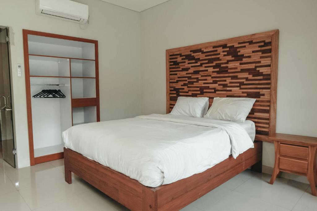 Postel nebo postele na pokoji v ubytování Sekar Arum Riverside Resort in Canggu