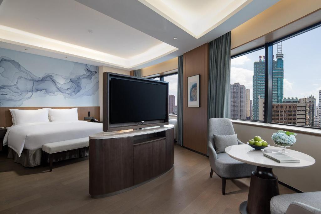 Postel nebo postele na pokoji v ubytování Foreign Trade Centre C&D Hotel,Fuzhou