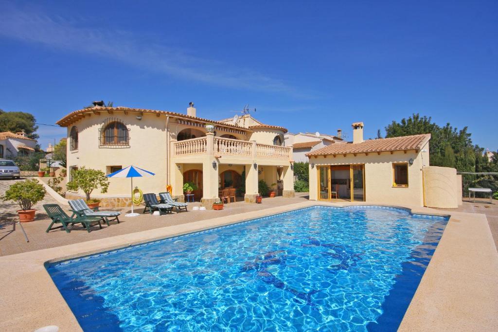 a large swimming pool in front of a house at Villa Odisea in Calpe