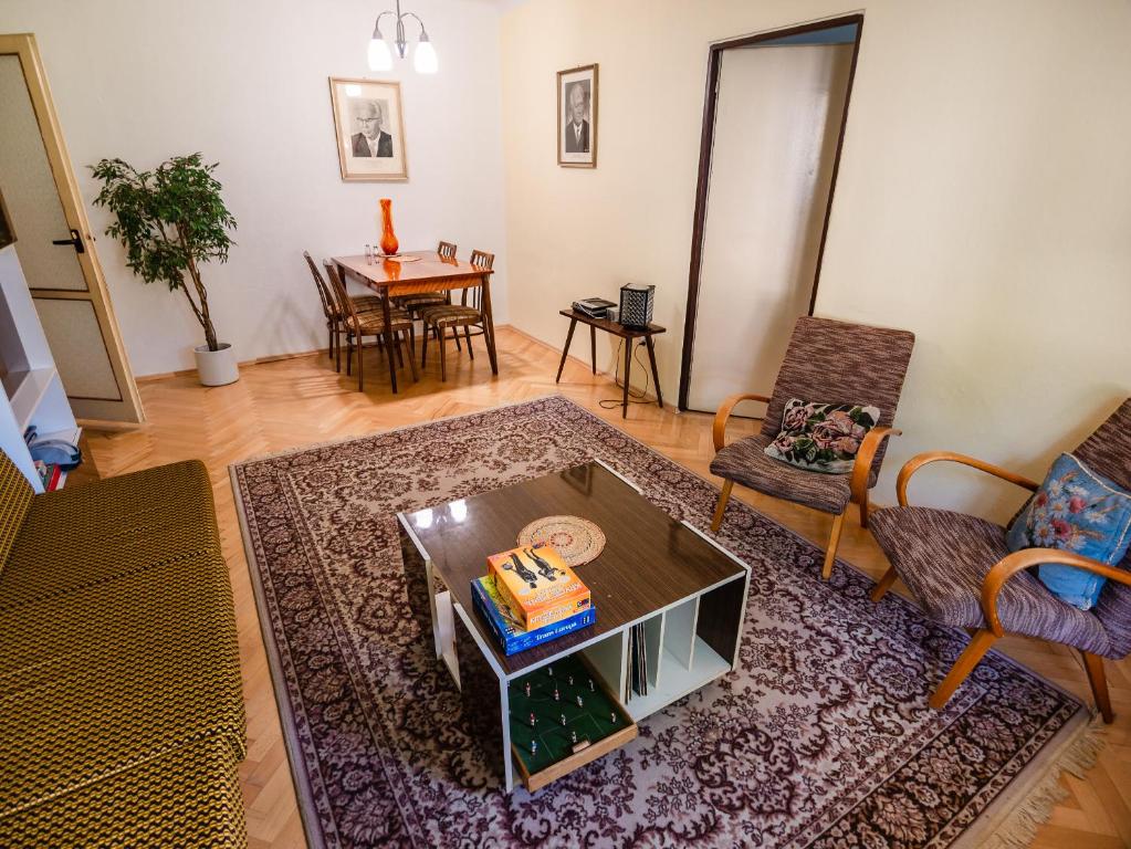 a living room with a coffee table and a couch at Retro Apartment in Brezno