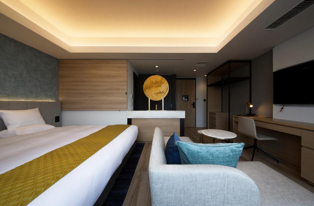 a hotel room with a bed and a tv at Nikko Style Nagoya in Nagoya