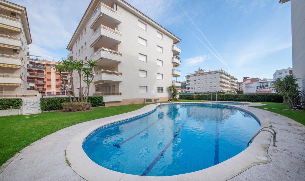 a swimming pool in front of a building at R114 Apartment Ca La Laura in Calafell