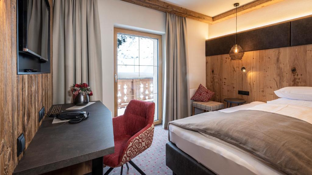 Posteľ alebo postele v izbe v ubytovaní Alpenresort Fluchthorn