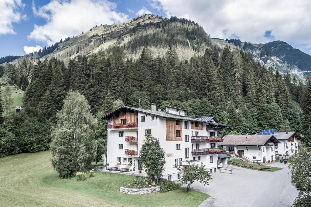 a resort with a mountain in the background at Vera Monti in Holzgau