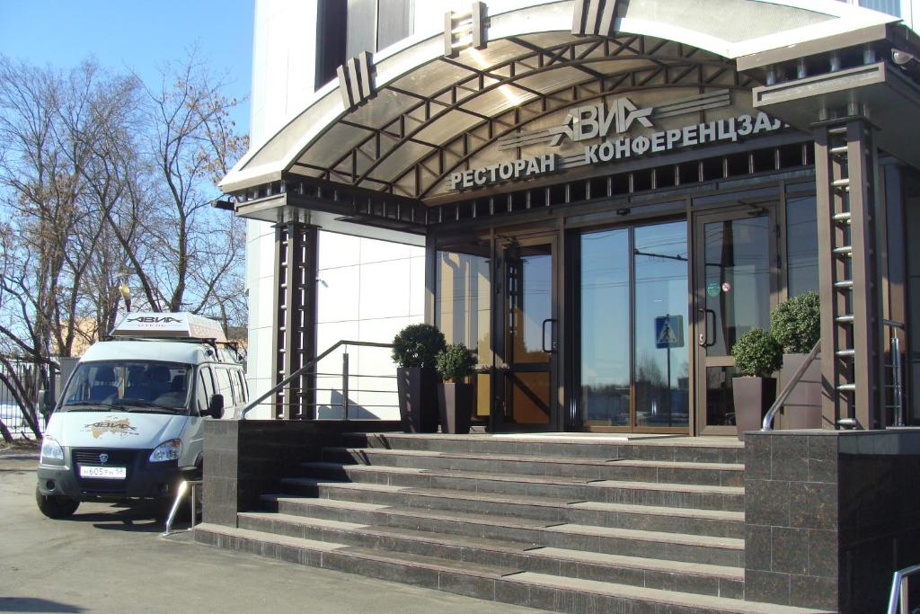 a van parked in front of a building at Hotel Avia in Penza