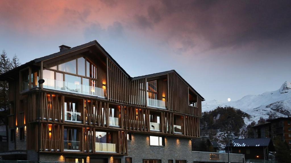 a house with wooden panels on the side of it at Chalet Blanc in Breuil-Cervinia