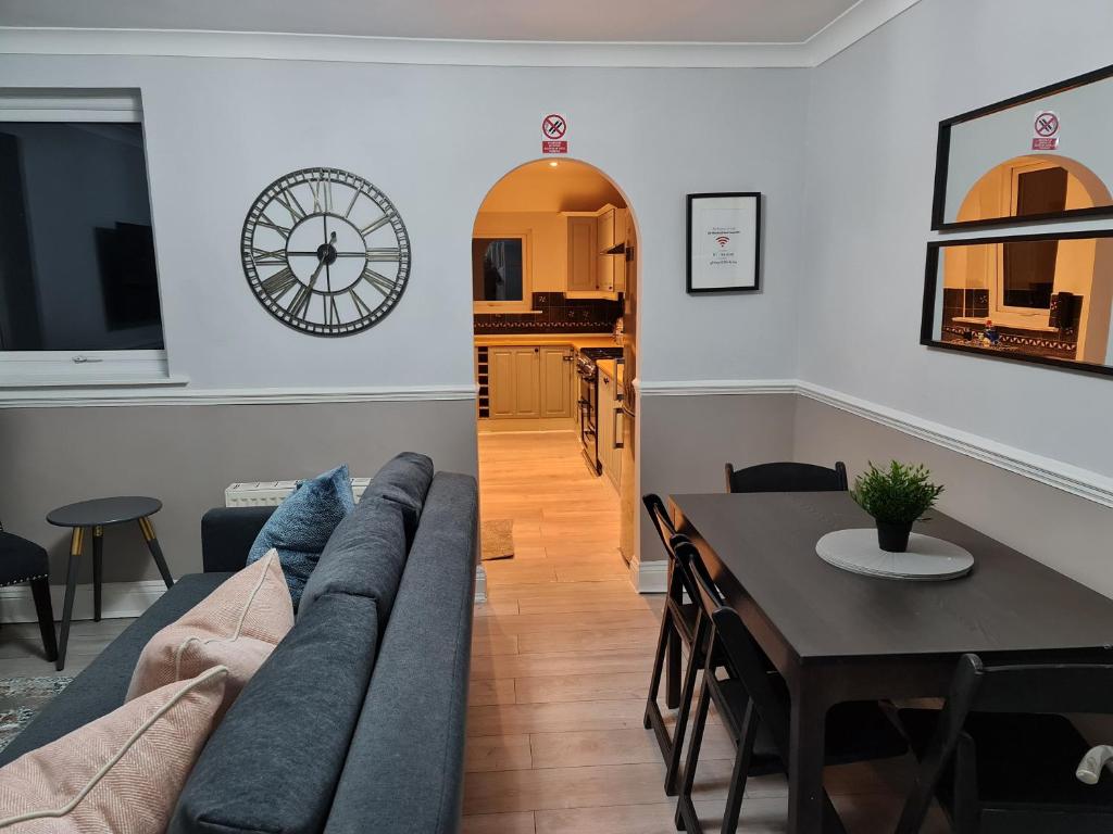 a living room and dining room with a couch and a table at Berrygate in Ipswich