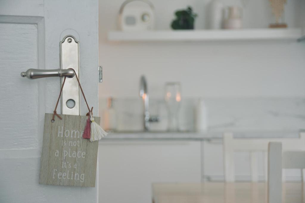 a paper bag hanging on a door in a kitchen at Kanne: charming house between nature and shopping in Kanne