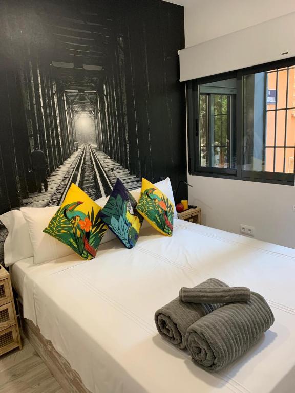 um quarto com uma cama branca e um mural de comboio na parede em T-Homes - Fuencarral em Madri