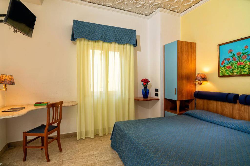 Postel nebo postele na pokoji v ubytování Hotel Vello d'Oro