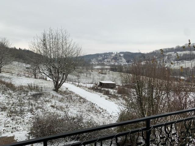 un campo cubierto de nieve con una valla y árboles en Ferienwohnung Limes en Aalen