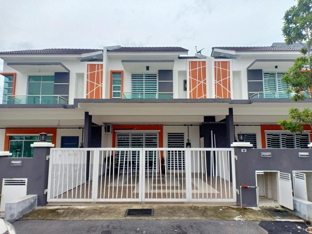 a house with orange doors and a white gate at As Syifaa Homestay Mslim only in Ipoh