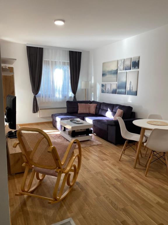 un soggiorno con divano e tavolo di Apartman Stella a Zlatibor