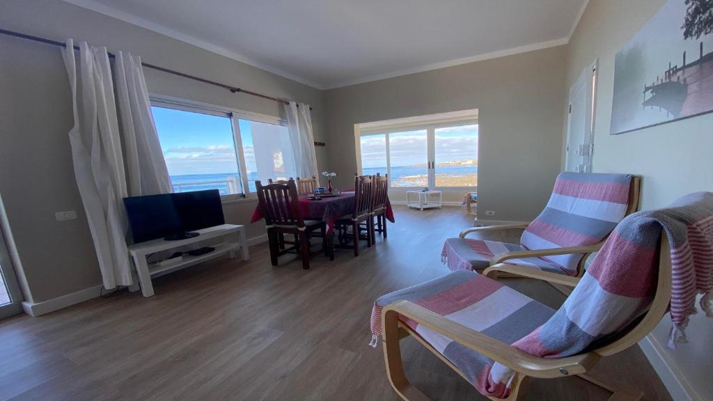 a living room with a table and chairs and a television at Casa Camilo I in Valle Gran Rey