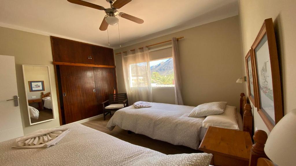 a bedroom with two beds and a ceiling fan at Casa Camilo I in Valle Gran Rey