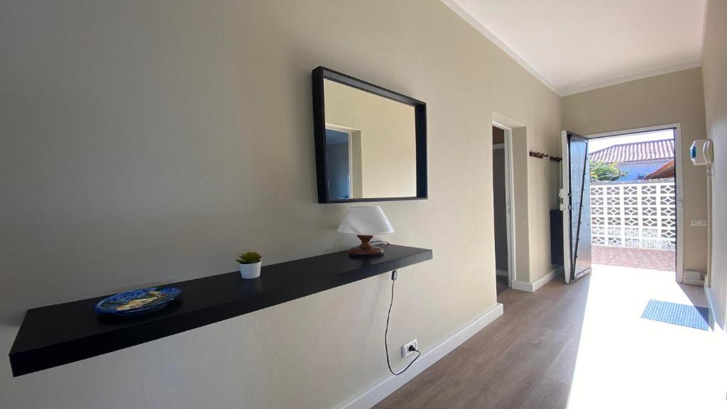 a living room with a table and a mirror on the wall at Casa Camilo I in Valle Gran Rey