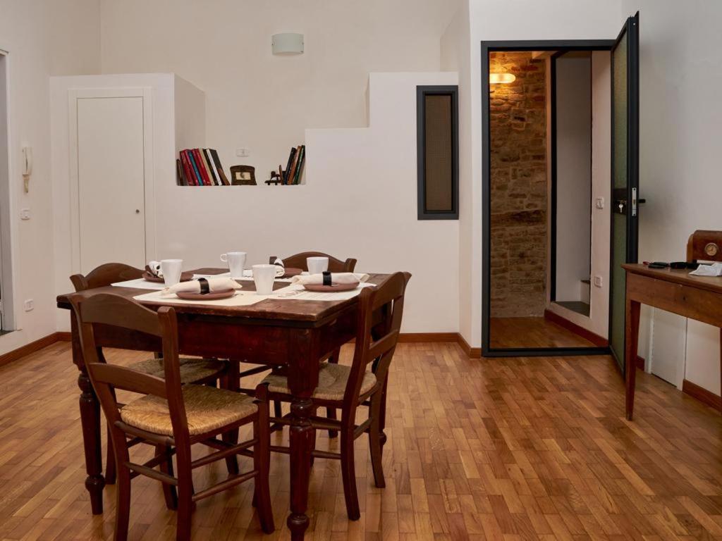 a dining room with a wooden table and chairs at La Casa di Giulia in Sarnano