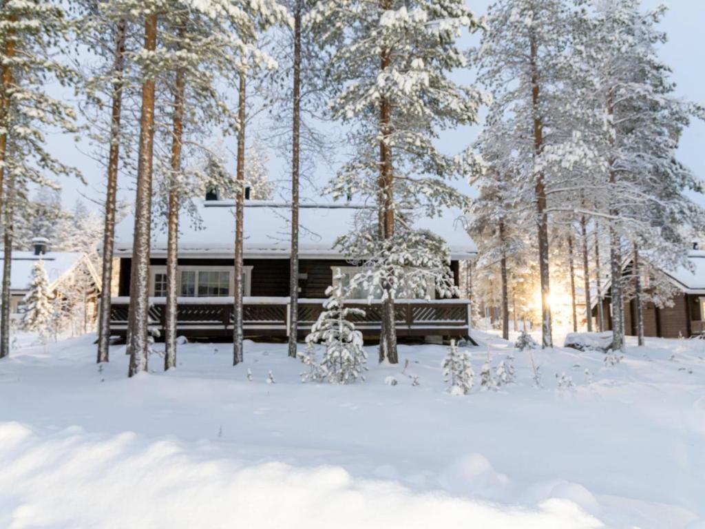a cabin in the woods in the snow at Holiday Home Nurmennunnu by Interhome in Levi