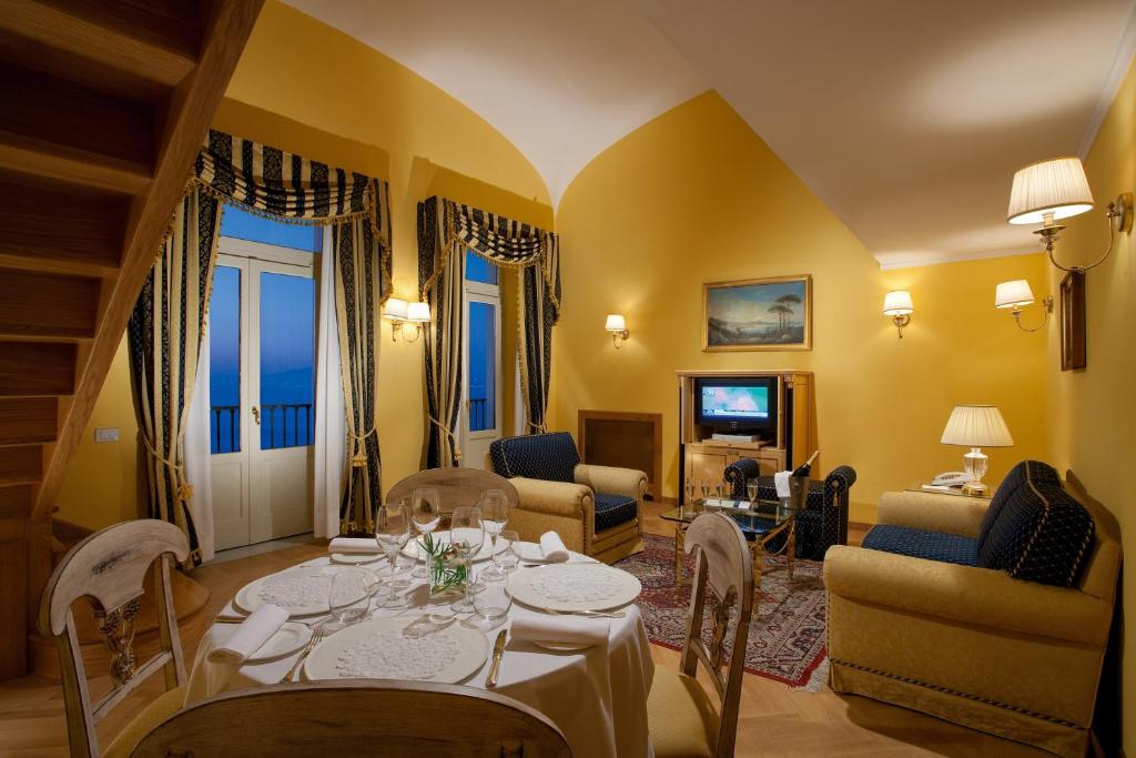 a living room with a table and chairs at Imperial Hotel Tramontano in Sorrento