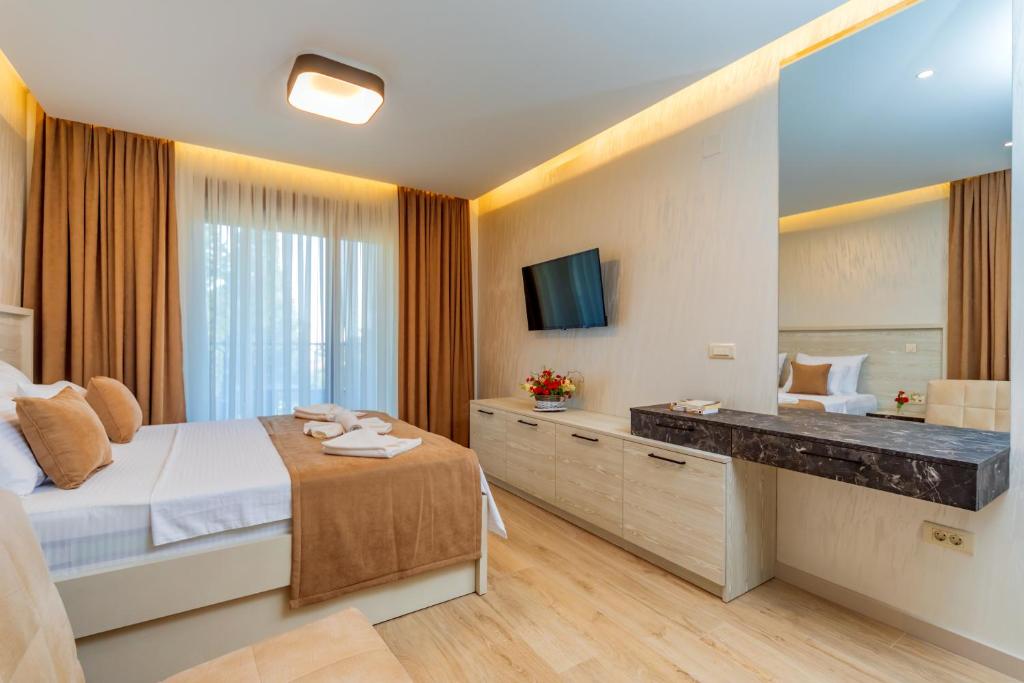 a bedroom with a large bed and a mirror at Luxury Apartments Queen in Petrovac na Moru