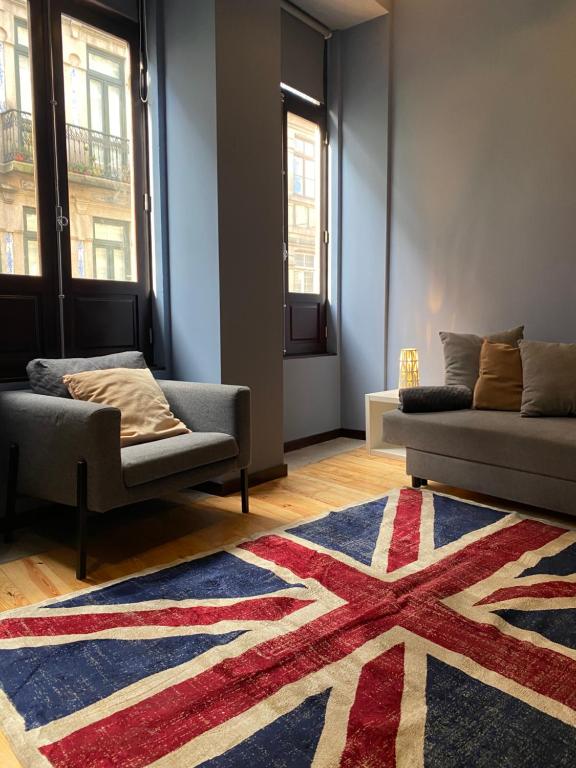 a living room with two couches and a rug at GaleriasApart in Porto