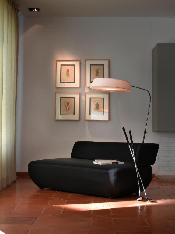 a living room with a black couch and a lamp at Parador de Málaga Golf in Málaga