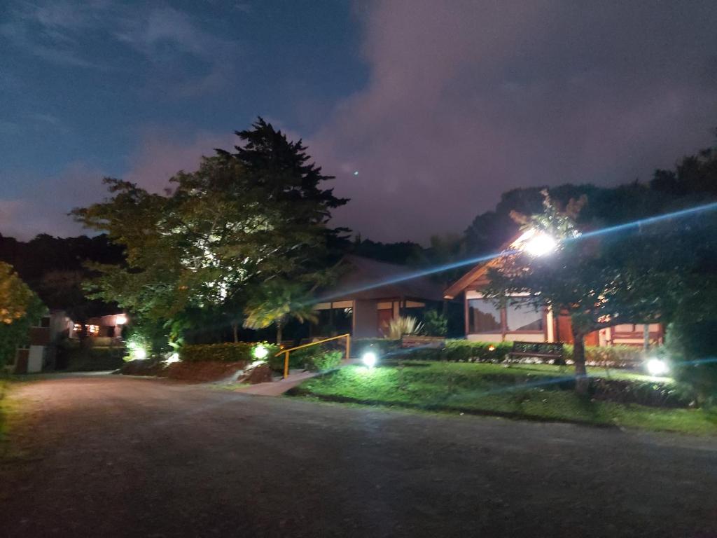 a house lit up at night with street lights at Bella Vista Lodge in Monteverde Costa Rica