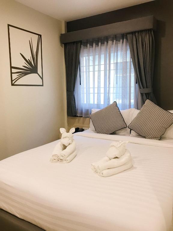 Postel nebo postele na pokoji v ubytování SJ Miracle Hotel