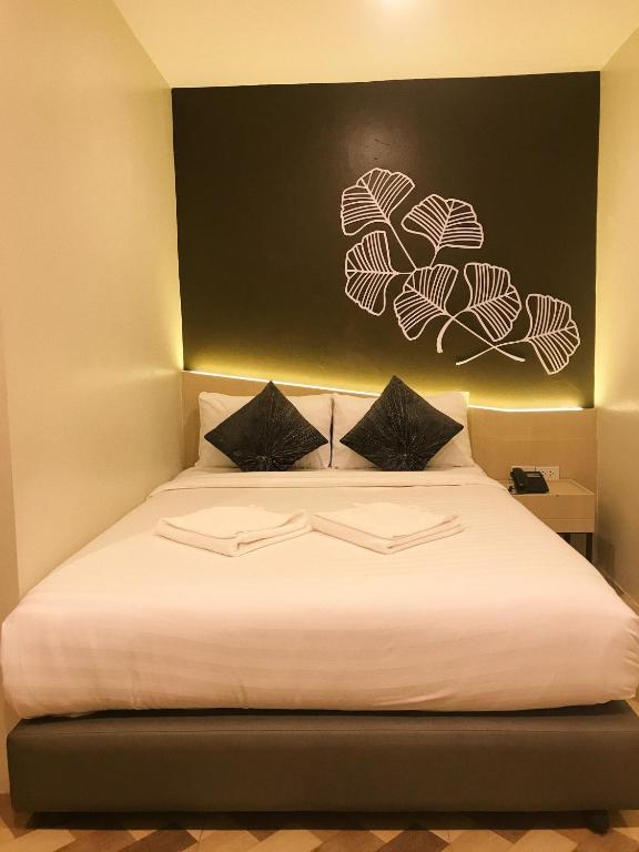 Postel nebo postele na pokoji v ubytování SJ Miracle Hotel
