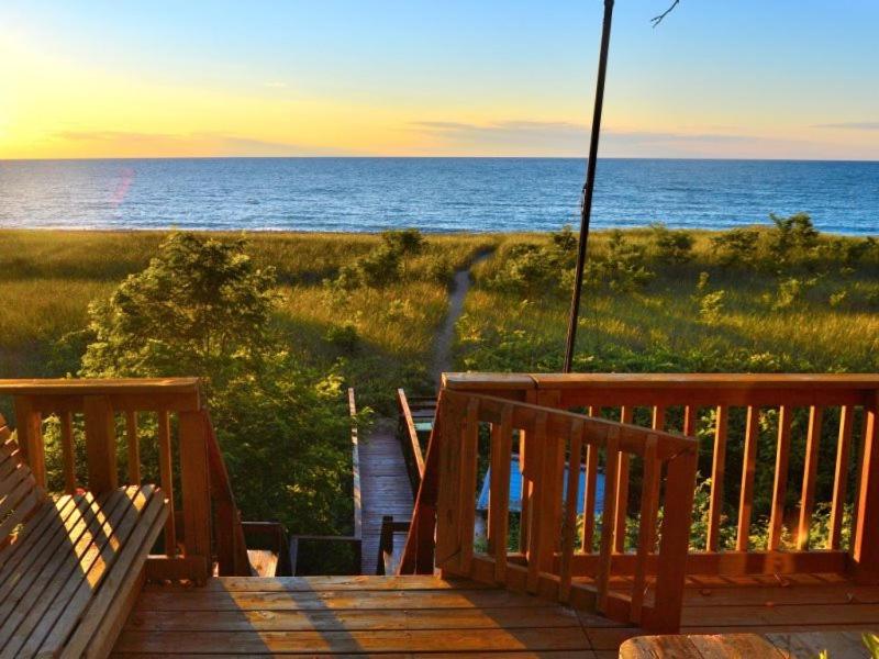 a wooden deck with a view of the ocean at The Pelton House in New Buffalo