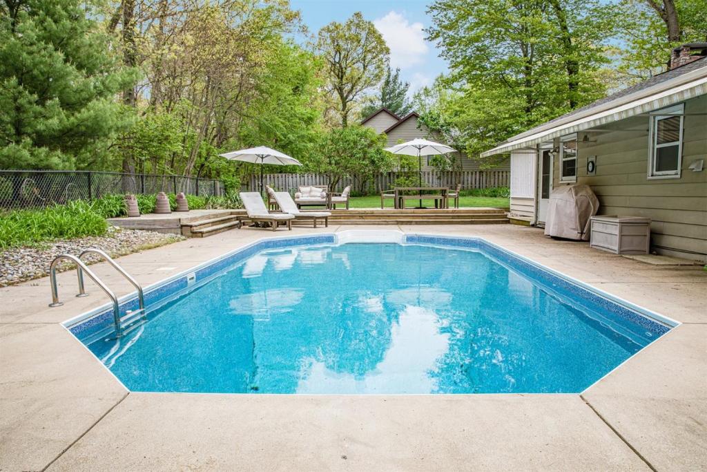 a swimming pool in the backyard of a house at Woodcrest Pool Paradise in New Buffalo