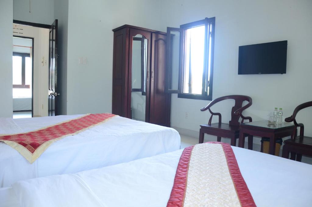 Ένα ή περισσότερα κρεβάτια σε δωμάτιο στο DTC Hotel