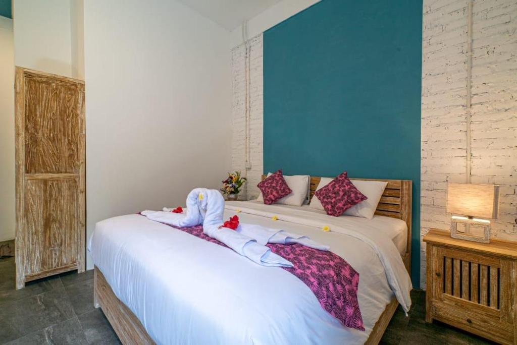 a bedroom with two beds with towels on them at EUFORIA Guest House in Canggu