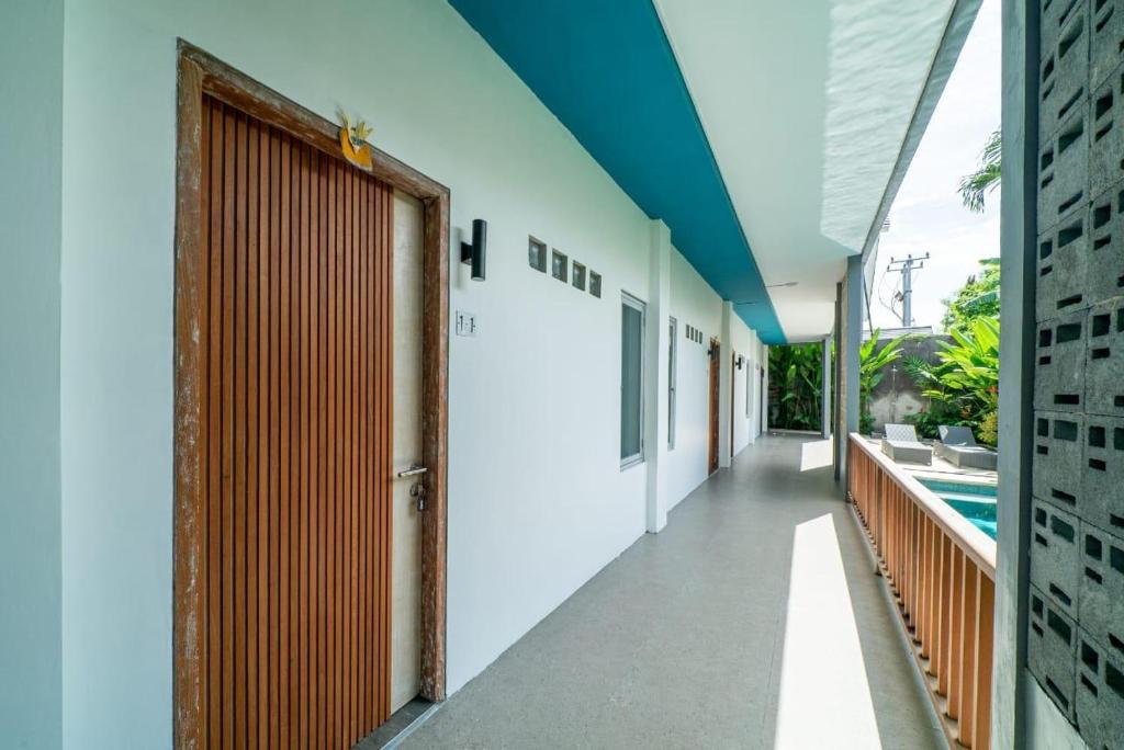 a corridor of a house with a door and a pool at EUFORIA Guest House in Canggu