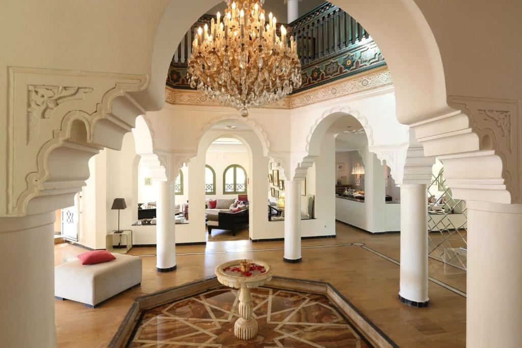 a large room with a chandelier and a living room at La Vie En Rose in Marrakech