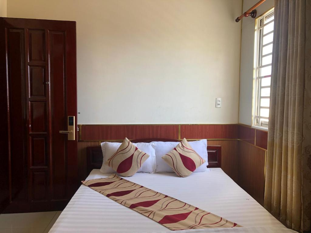 - une chambre avec un lit avec deux oreillers et une fenêtre dans l'établissement Hong Dao 2 Hotel, à Cần Thơ