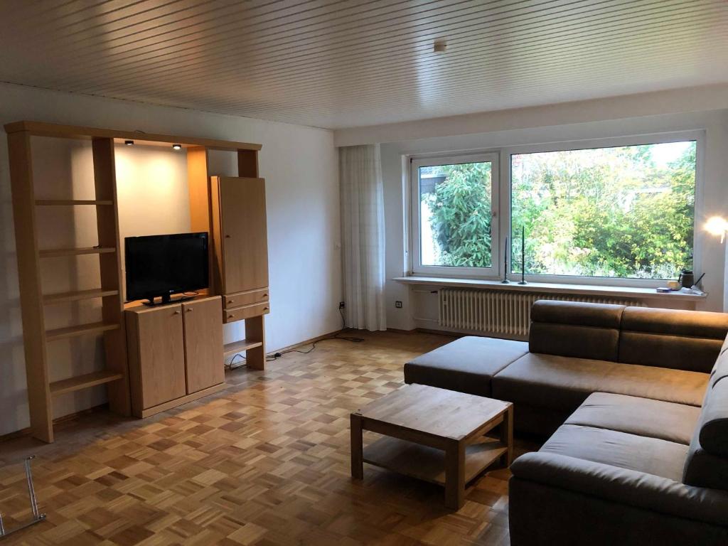 a living room with a couch and a flat screen tv at Grosszuegige Ferienwohnung in ruhiger Lage in Fulda