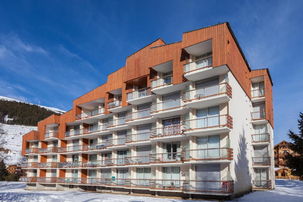 a building with snow in front of it at Vacancéole - Résidence Côte Brune in Les Deux Alpes