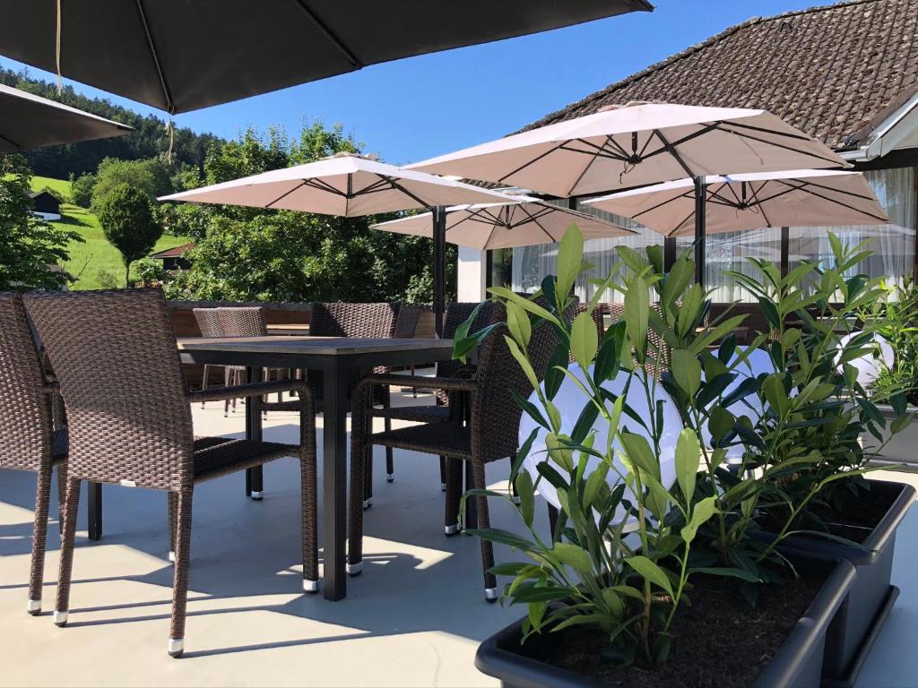 a table and chairs with umbrellas on a patio at Gasthof und Pension Haunschmid in Rechberg